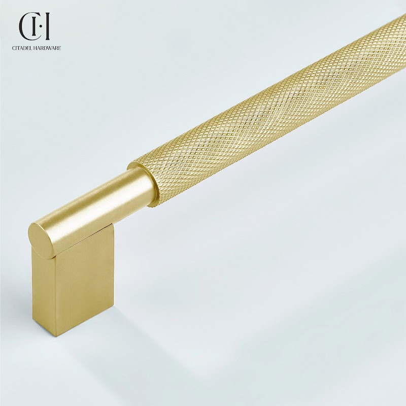Close-up of a gold solid brass cabinet handle with a knurled grip by Citadel Hardware